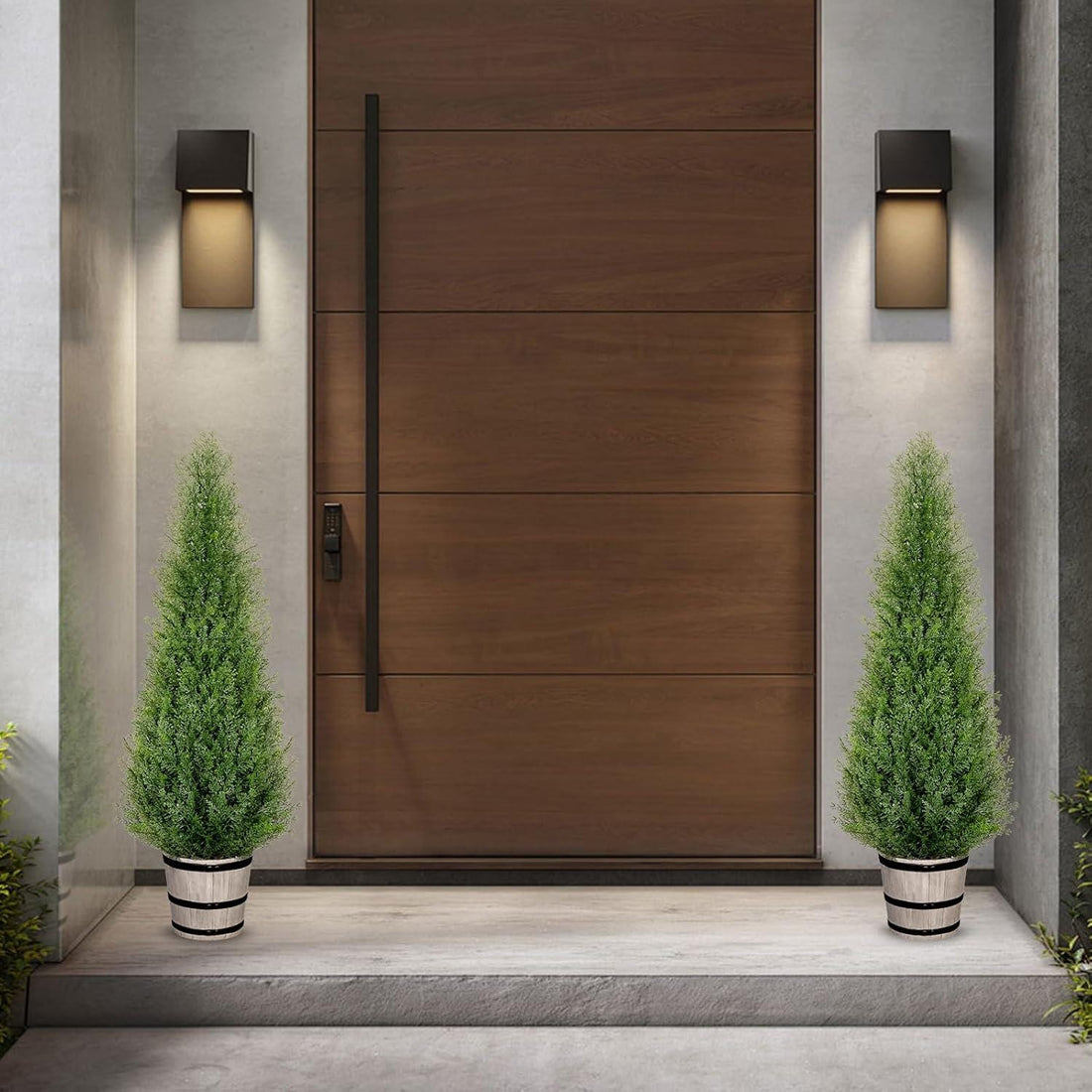 Pair of three-foot artificial cedar topiary trees in rustic barrel planters framing a porch