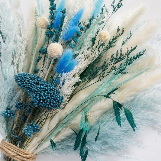 Boho room styled with dried flowers, pampas grass, a neutral vase, and natural textures