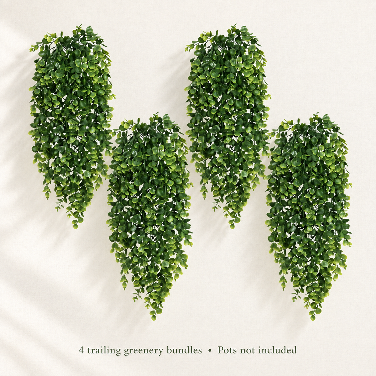 Four trailing artificial greenery bundles with small oval leaves — airy portrait