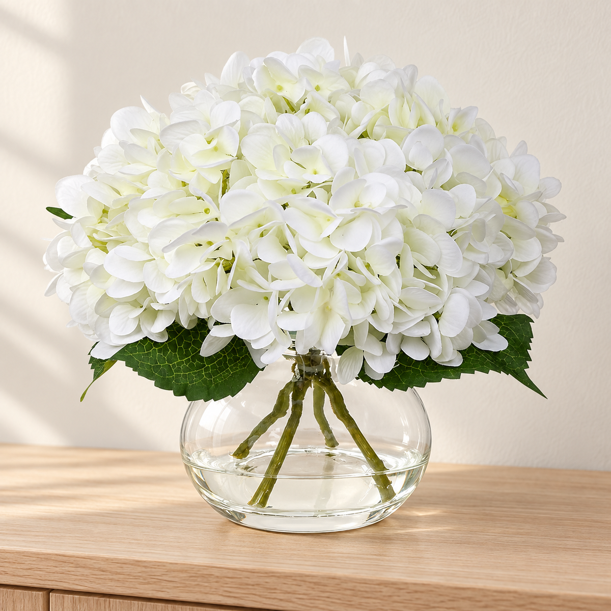 White hydrangea arrangement in glass vase with faux water — main